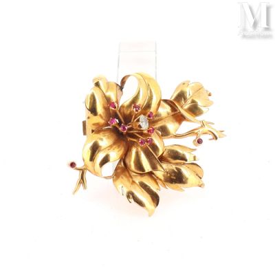 an image of a gold flower brooch with pink and white stones