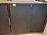 a black cabinet with a yellow sticker on the side of it