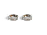 two silver rings with words on them sitting next to each other