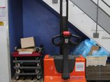 a forklift sitting in front of a set of stairs