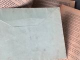 an old envelope sitting on top of an open book