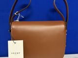 a close up of a brown purse with a tag on it