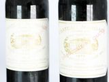 two bottles of wine sitting next to each other on a table
