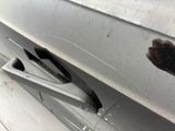 a hand that is holding something in the door of a car
