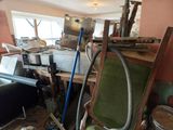 an image of a cluttered room with a chair and other items