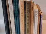 several books are stacked on top of each other on a table