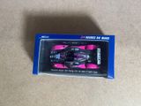 a pink toy car in a blue box on the floor