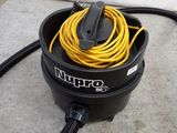 a black and yellow vacuum with a yellow cord in it