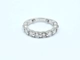 a close up of a diamond ring on a white surface
