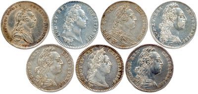 a group of six silver coins with heads of people on them