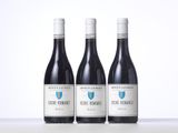 three bottles of wine sitting on top of a table next to each other
