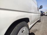 a white van that is parked in a parking lot