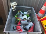 a container full of trash sitting next to a construction cone