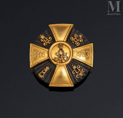 an image of a gold and black medal with a cross on it