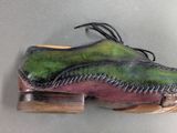 a pair of shoes that have been painted green and pink