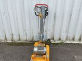 an image of a small machine that is sitting on the ground