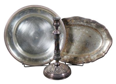 two silver trays and a silver plate on a stand