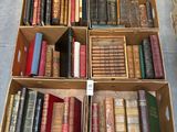 several boxes of books are stacked on top of each other
