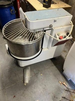 a mixer that is sitting on the floor in a room