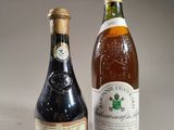 two bottles of wine sitting next to each other on a table