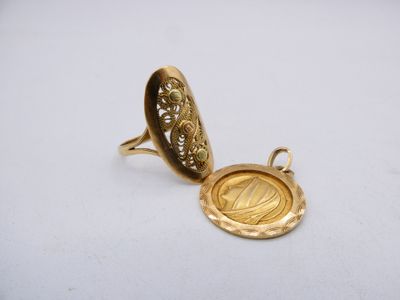 a close up of a gold locke with a medallion on it