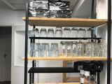 a shelf with wine glasses on it in a room