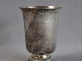 a silver cup that is sitting on a table