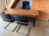 a desk and chairs in a room with a stair case
