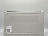 an open laptop computer sitting on top of a white surface