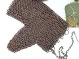 a brown crochet bag and a pair of scissors on a white surface