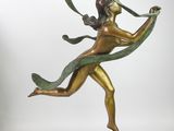 bronze statue of a woman holding a green ribbon on a base