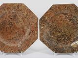 pair of brown marble plates on stands on a white surface