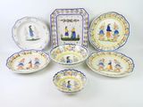 several plates and bowls are arranged on a white surface