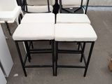 several chairs and stools are stacked on top of each other in front of a refrigerator