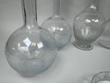 three glass vases sitting on a table next to each other