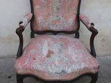 a chair with a pink upholstered upholstered seat