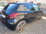 the back of a black car parked on a cobblestone street