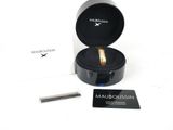 a box with a ring inside of it on a white surface