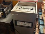 a machine that is sitting next to a pile of crates