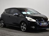 a black car parked in a room with a checkered floor
