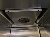 a stainless steel oven with a fan on top of it
