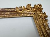 a picture of a gold frame with flowers and leaves on it