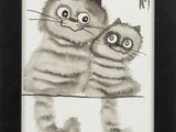 a picture of two cats that are sitting together