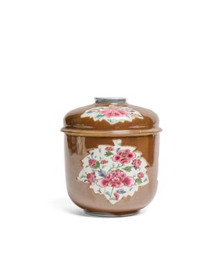 an image of a brown jar with a floral design on it