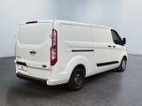 the rear of a white van parked in a large room