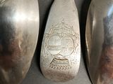 three spoons sitting next to each other on a table