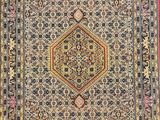 an antique persian rug with a medallion design on a red ground