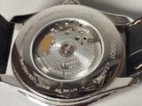 a close up of a watch on a white surface