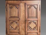 an old wooden cabinet with two doors and a door handle