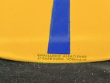 a yellow plate with a blue stripe on it